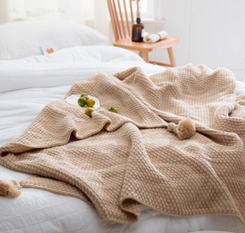 Textured Knit Throw Blanket with Tassels, soft waffle weave fabric in warm beige tone for cozy and decorative comfort