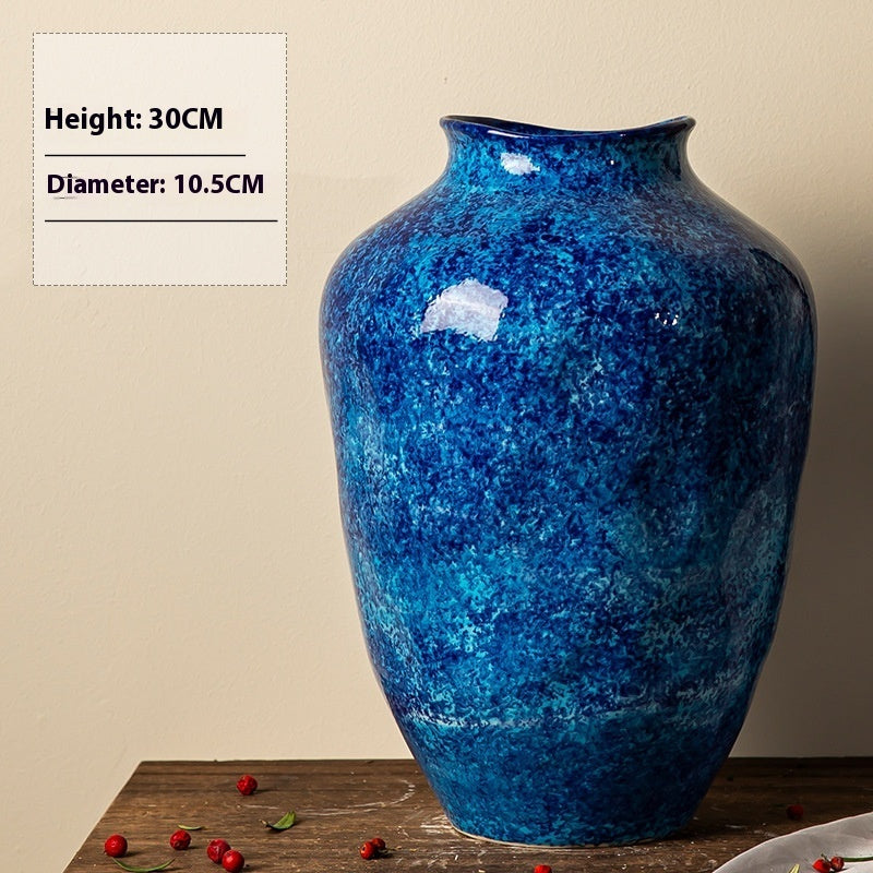 Blue textured vase on a wooden surface with measurements displayed.