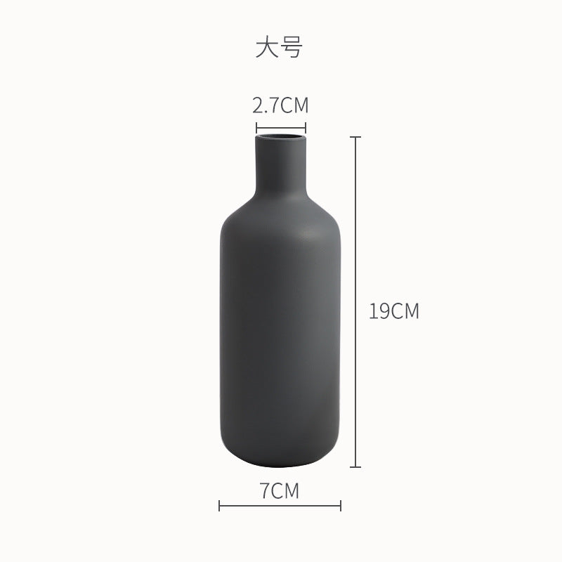 Minimal Bottle Vase, matte black ceramic with slender neck and rounded body silhouette