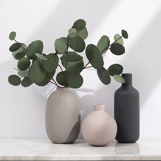 Minimal Ceramic Vase Trio, matte neutral-toned ceramics in rounded and bottle silhouettes styled with eucalyptus stems