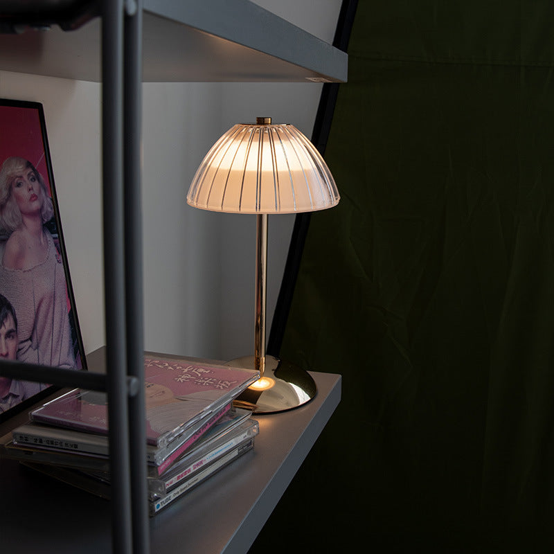Aurielle touch lamp lit showing warm diffused light in evening bedroom setting