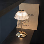 Aurielle touch table lamp with soft fabric shade and warm ambient glow on bedside table