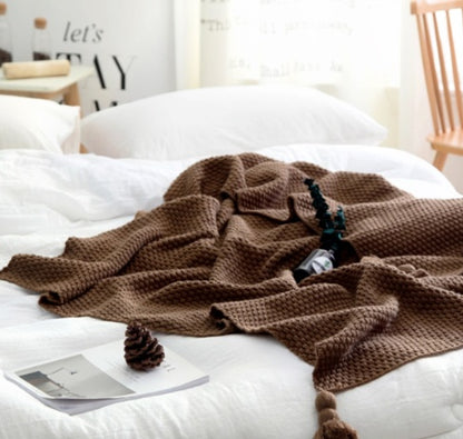 Textured Knit Throw Blanket with Tassels, soft waffle weave fabric in rich brown tone for cozy and decorative comfort