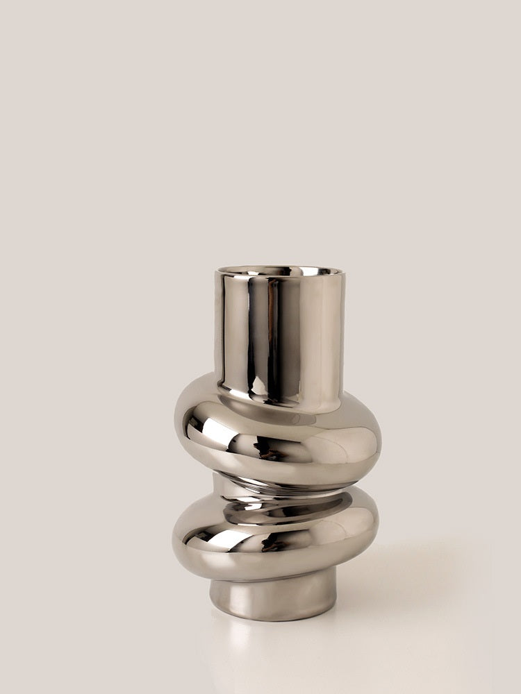 Sculptural Twist Vase, reflective chrome-finish ceramic with elongated neck and wrapped curved form