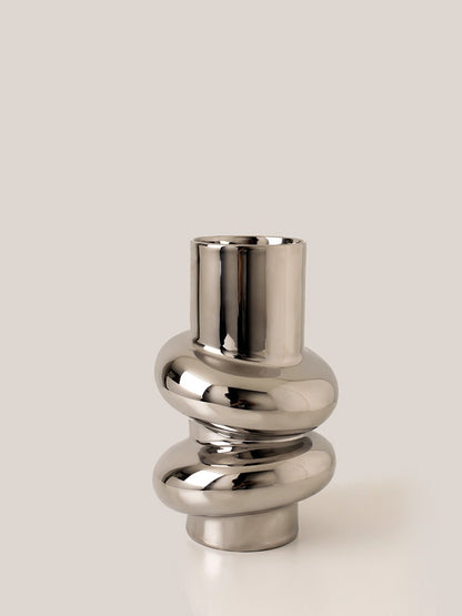 Sculptural Twist Vase, reflective chrome-finish ceramic with elongated neck and wrapped curved form