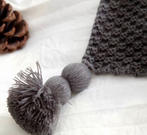 Textured Knit Throw Blanket with Tassels, soft waffle weave fabric in dark gray tone for cozy decorative layering