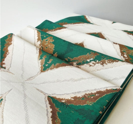 Geometric Patchwork Table Runner, cream fabric with deep green panels and metallic gold accents in angular design