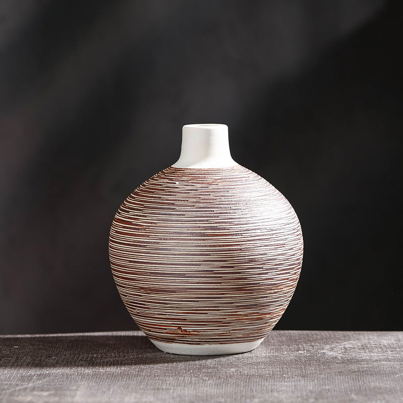 Round squat ceramic vase with fine red-brown horizontal stripe texture on dark grey background