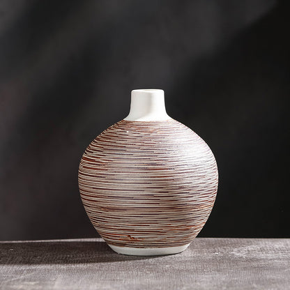 Round squat ceramic vase with fine red-brown horizontal stripe texture on dark grey background