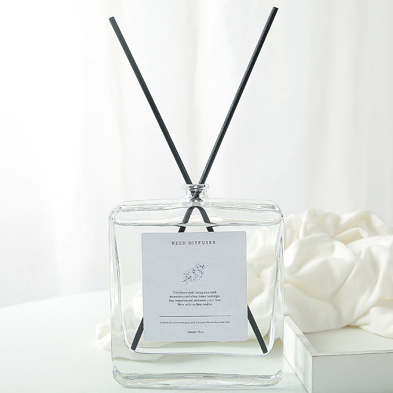 Minimalist Glass Reed Diffuser, clear square aromatherapy bottle with black reed sticks for clean and elegant home fragrance decor