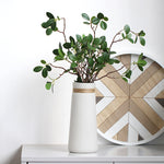 Minimal Rope Accent Vase, matte white ceramic with tapered silhouette and natural jute band detail holding leafy green stems