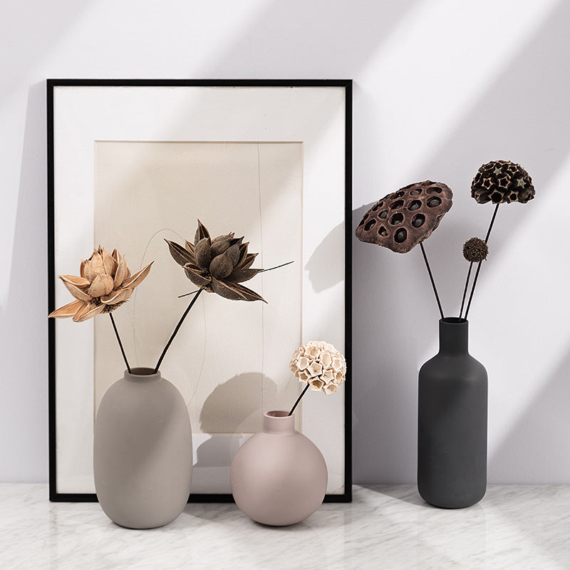 Minimal Ceramic Vase Trio, matte neutral-toned ceramics in oval, round, and bottle silhouettes styled with dried botanical stems