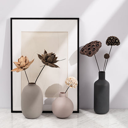Minimal Ceramic Vase Trio, matte neutral-toned ceramics in oval, round, and bottle silhouettes styled with dried botanical stems