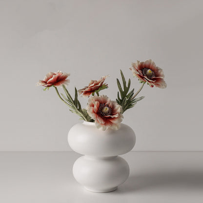 Double Orb Vase, matte white ceramic with rounded stacked form holding soft blush-toned floral stems