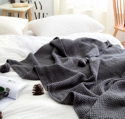 Textured Knit Throw Blanket with Tassels, soft waffle weave fabric in dark gray tone for cozy and decorative comfort