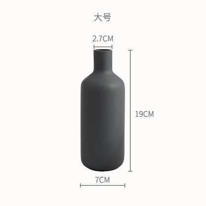 Minimal Bottle Vase, matte black ceramic with slender neck and rounded body silhouette