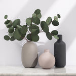 Minimal Ceramic Vase Trio, matte neutral-toned ceramics in rounded and bottle silhouettes styled with eucalyptus stems