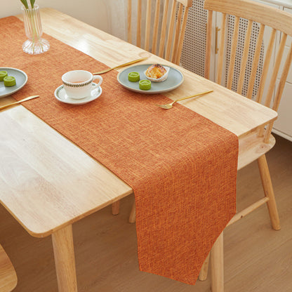 Textured Linen Table Runner, burnt orange woven fabric with subtle crosshatch pattern and soft drape