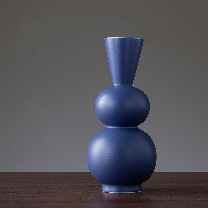 Blue vase on a wooden surface with a gray background
