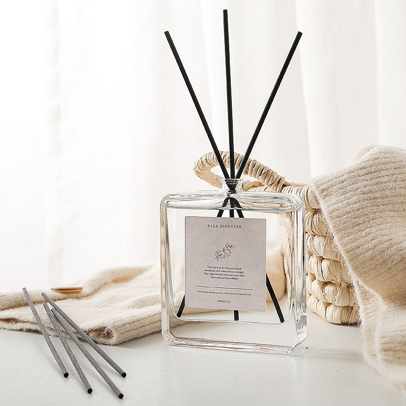 Minimalist Glass Reed Diffuser, clear square bottle with black reed sticks for elegant and long-lasting home fragrance