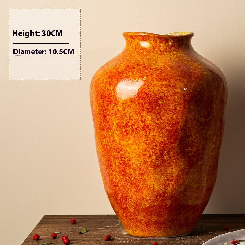 Orange ceramic vase on a wooden surface with measurements displayed.