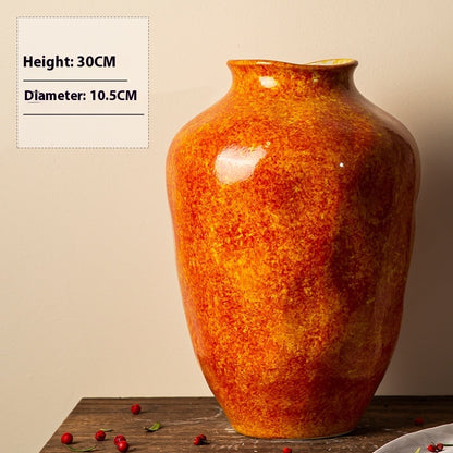 Orange ceramic vase on a wooden surface with measurements displayed.