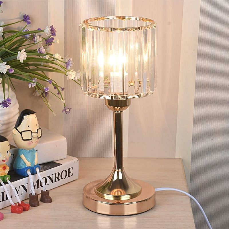 Crystal Column Table Lamp, clear ribbed glass shade with gold metal base and warm glowing light