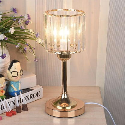 Crystal Column Table Lamp, clear ribbed glass shade with gold metal base and warm glowing light