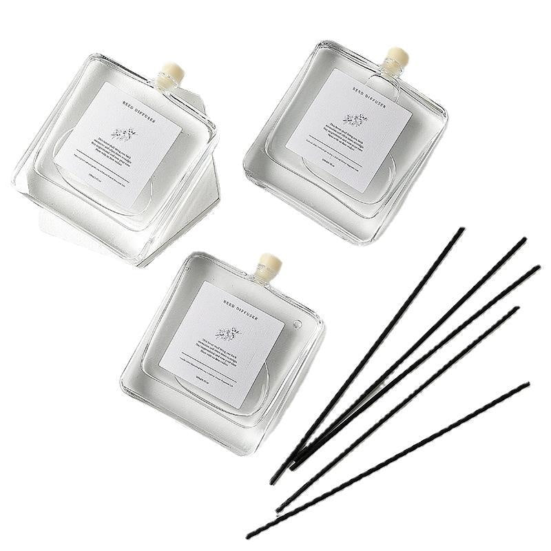 Minimalist Glass Reed Diffuser Set, clear square refill bottles with black reed sticks for clean, modern and long-lasting home fragrance