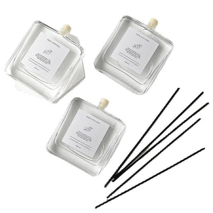 Minimalist Glass Reed Diffuser Set, clear square refill bottles with black reed sticks for clean, modern and long-lasting home fragrance