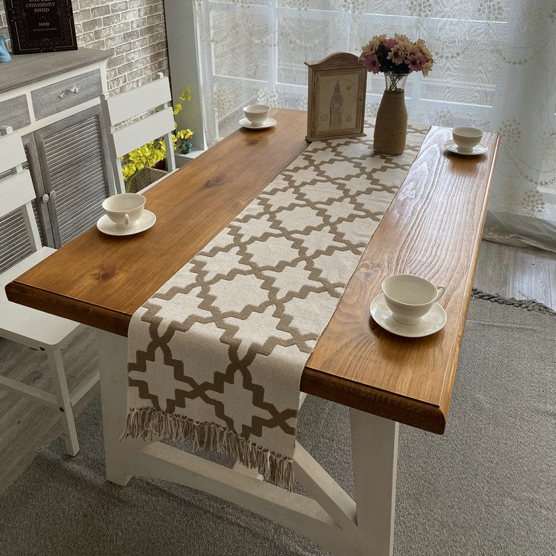 Geometric Trellis Table Runner, cream woven fabric with beige lattice pattern and tasseled edges